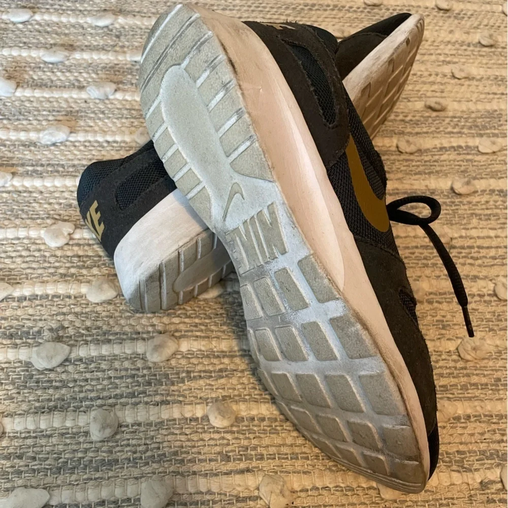 Nike Women’s 8.5 Black and Gold Sneakers